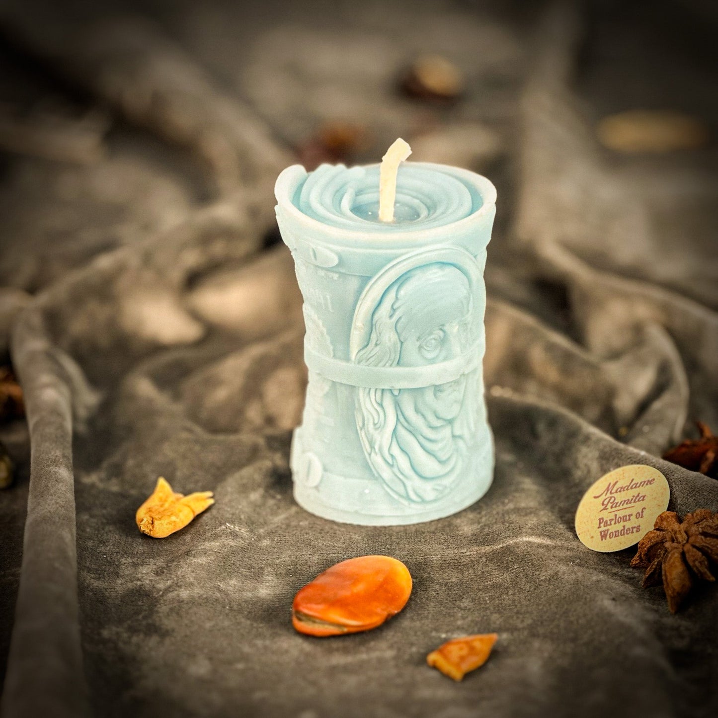 Decorative candle with intricate design on a textured surface