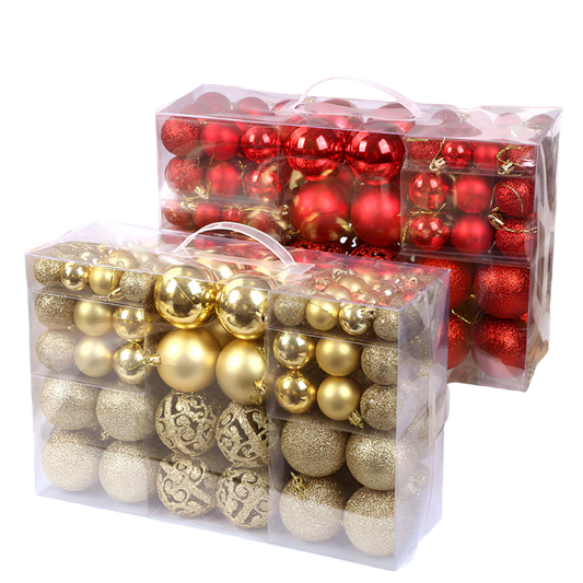 Clear plastic boxes filled with red and gold Christmas ornaments on a white background.