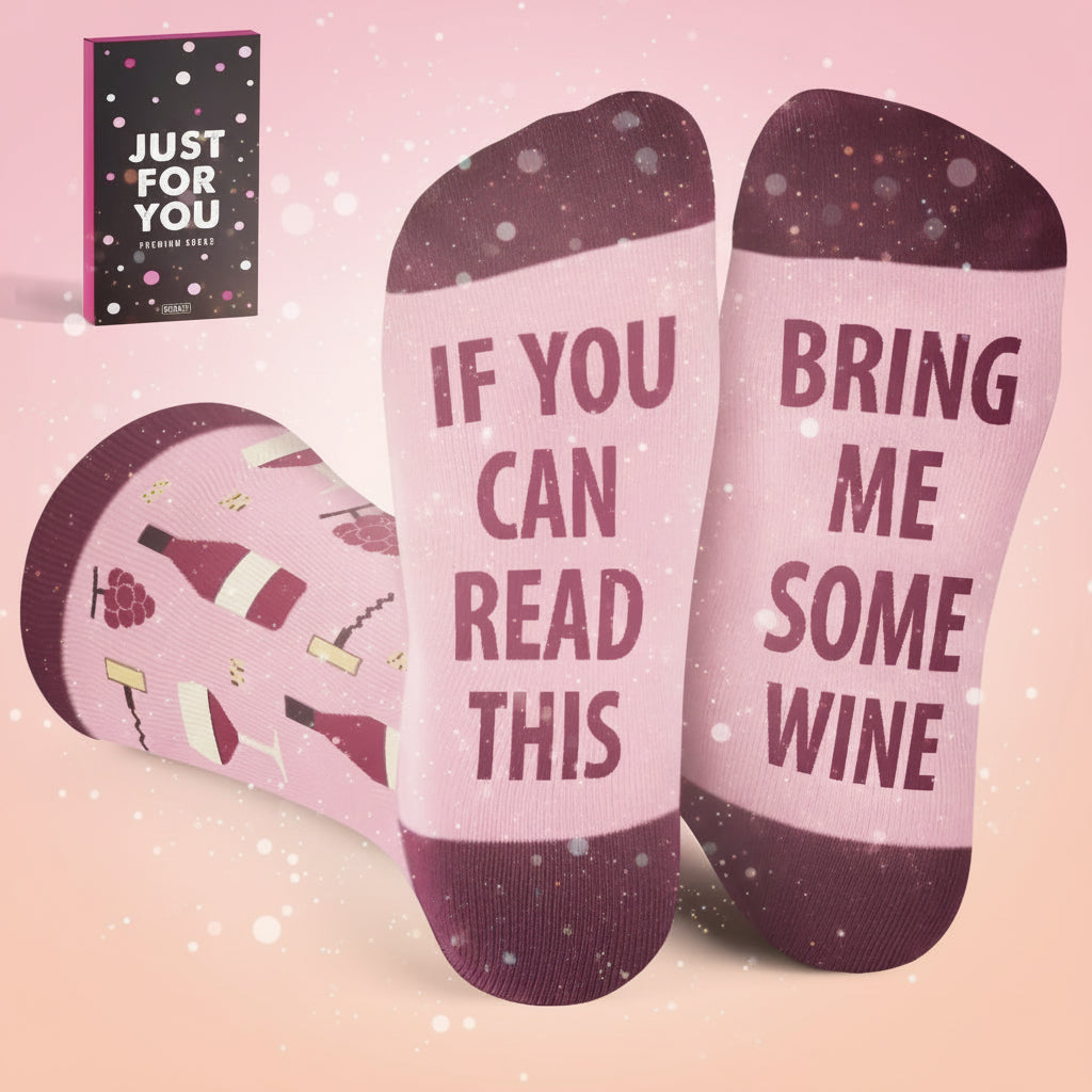 Pink socks with text and wine graphics, paired with a small gift box.