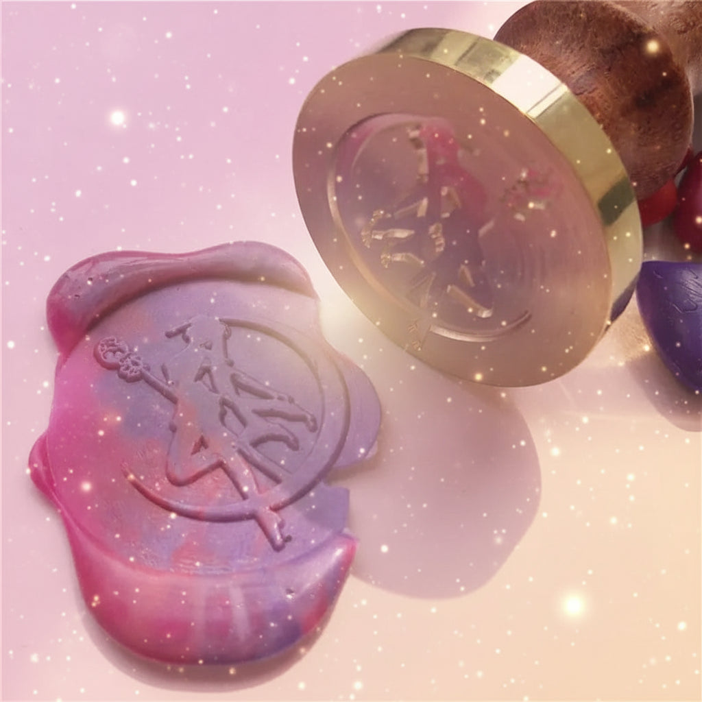 Colorful wax seal stamp with a gold and wooden handle on a white background