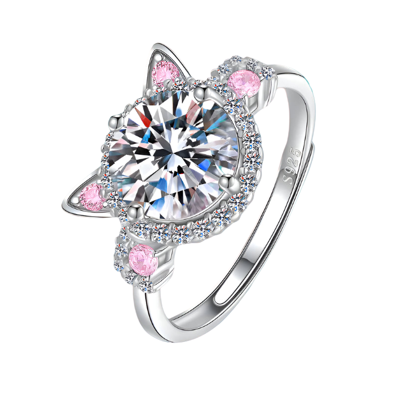 Silver ring with heart-shaped gem and pink accents on a white background