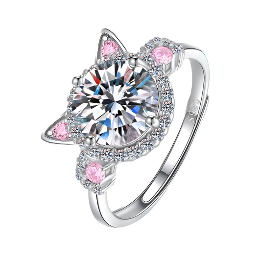 Silver ring with heart-shaped gem and pink accents on a white background