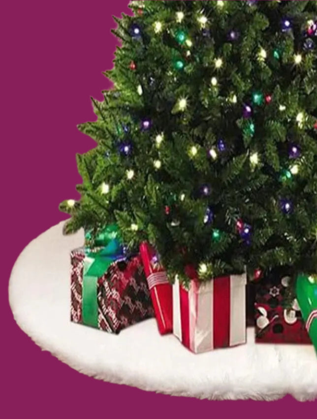 Decorated Christmas tree with lights and presents in a living room with a fireplace.