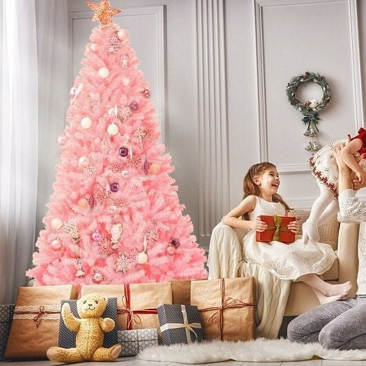 Pink Christmas tree decorated with ornaments in a living room setting.