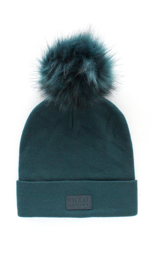 Teal beanie with fur pom-pom on a white background