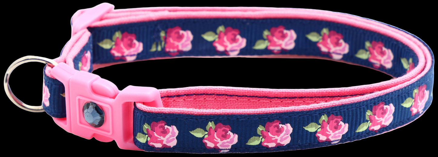 Navy blue dog collar with pink floral pattern on a white background