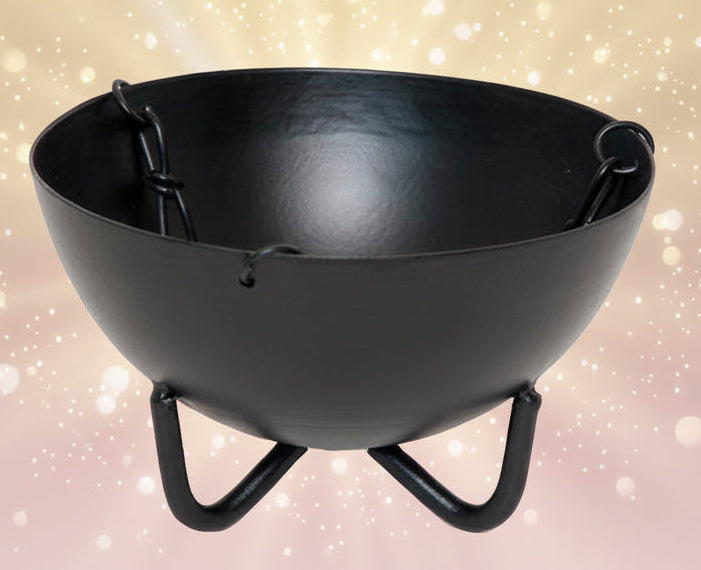Black metal fire pit bowl with stand on a white background