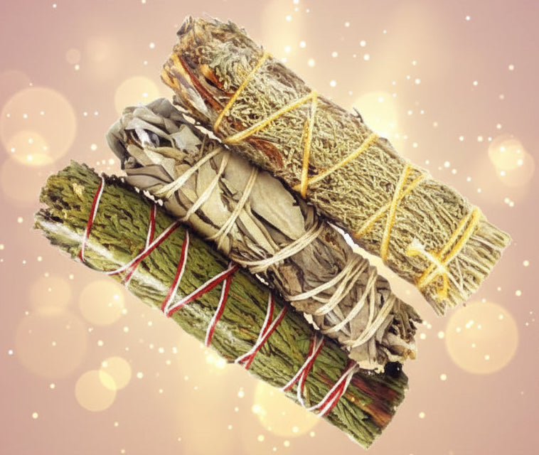 Three bundles of green herbs tied with red, yellow, and white string on a white background