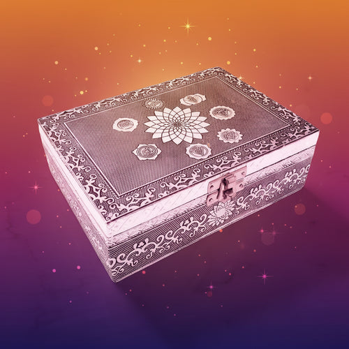 Decorative silver box with intricate patterns on a marble surface