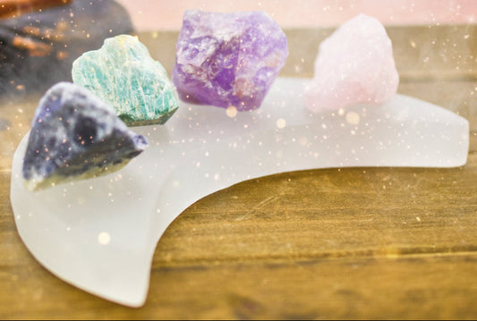 Set of colorful crystals on a white stone stand against a wooden background