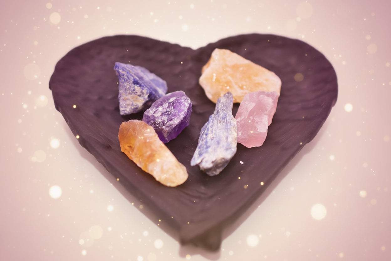 Colorful crystals on a black heart-shaped dish
