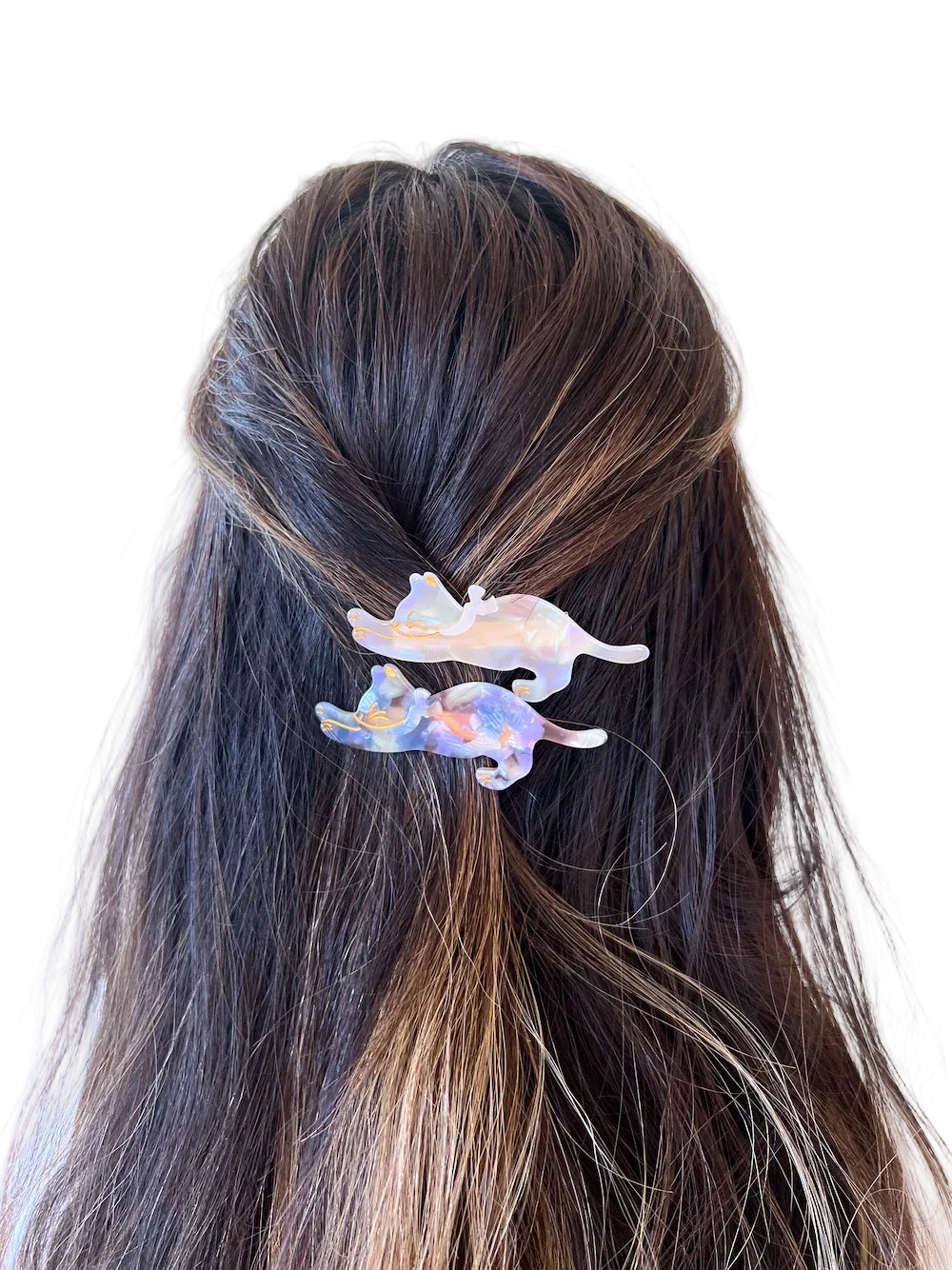 Hair clip with a colorful design on dark hair against a white background