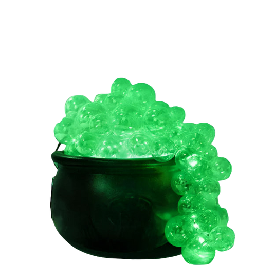Halloween-themed decor with a glowing green cauldron and festive lights.