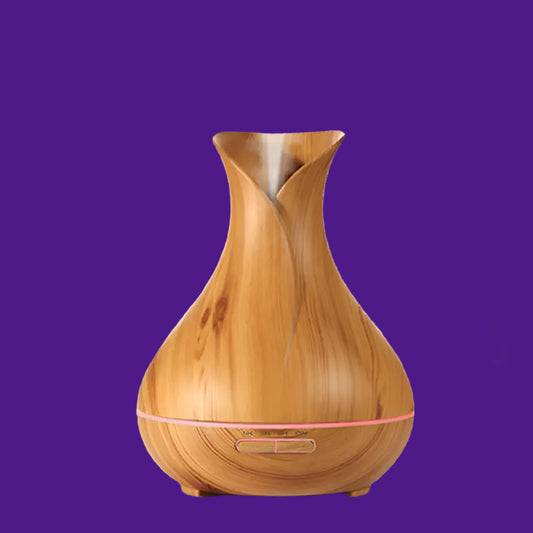 Wooden diffuser on a table with a plant in the background