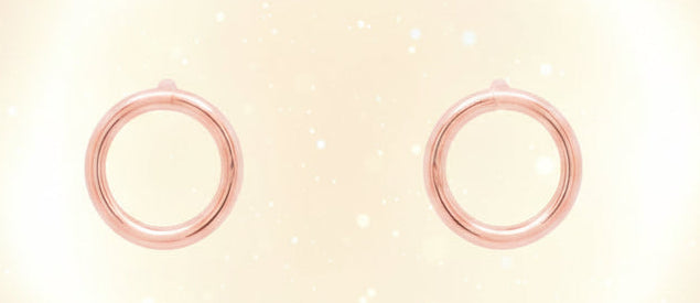 Rose gold hoop earrings on a white background