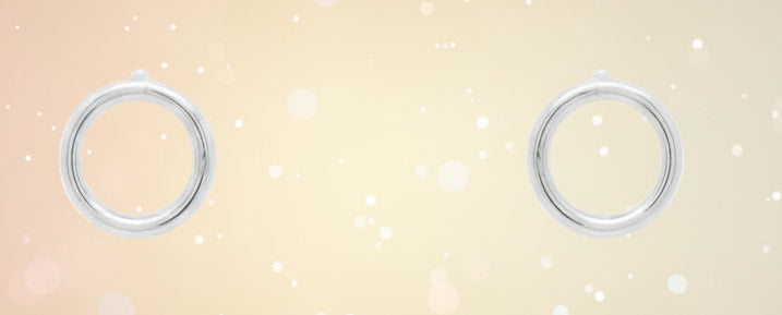 Pair of silver hoop earrings on a white background