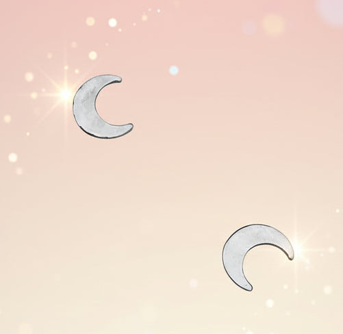 Two silver crescent moon earrings on a white background