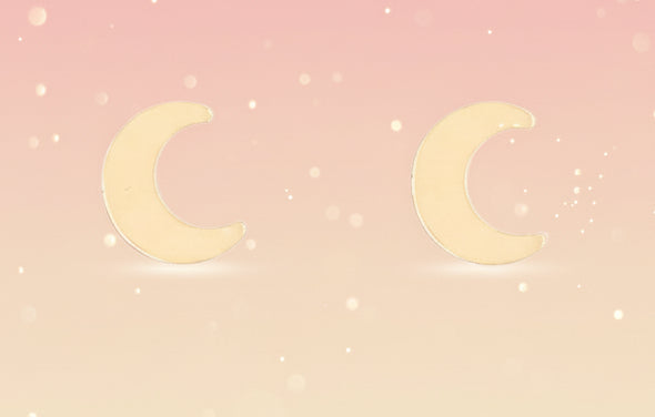 Pair of gold crescent moon earrings on a white background