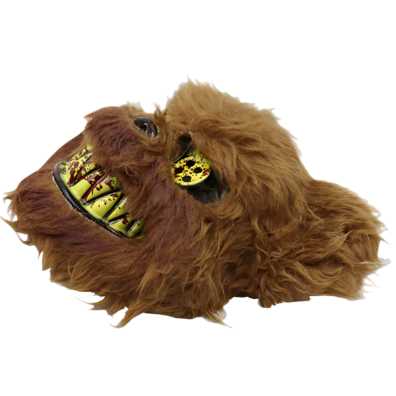 Brown furry slippers with a design resembling a creature's face on a white background