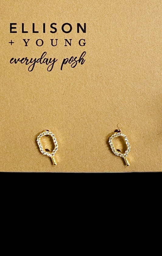 Gold earrings on a 'Ellison + Young' branded card with pebbles and greenery in the background
