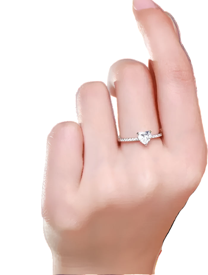 Heart-shaped diamond ring on a finger against a neutral background