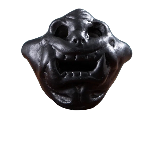 Stress relief toy with a dark, textured surface on a decorative background.