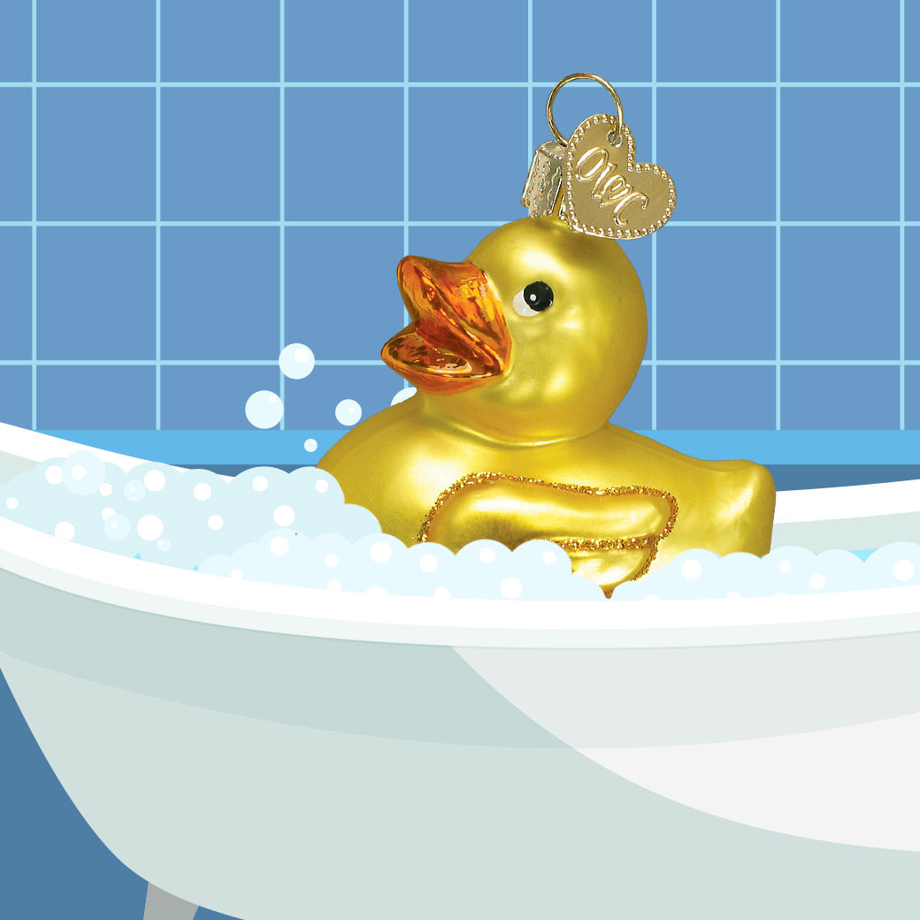 Gold rubber duck in a bathtub with bubbles against a blue tiled wall.