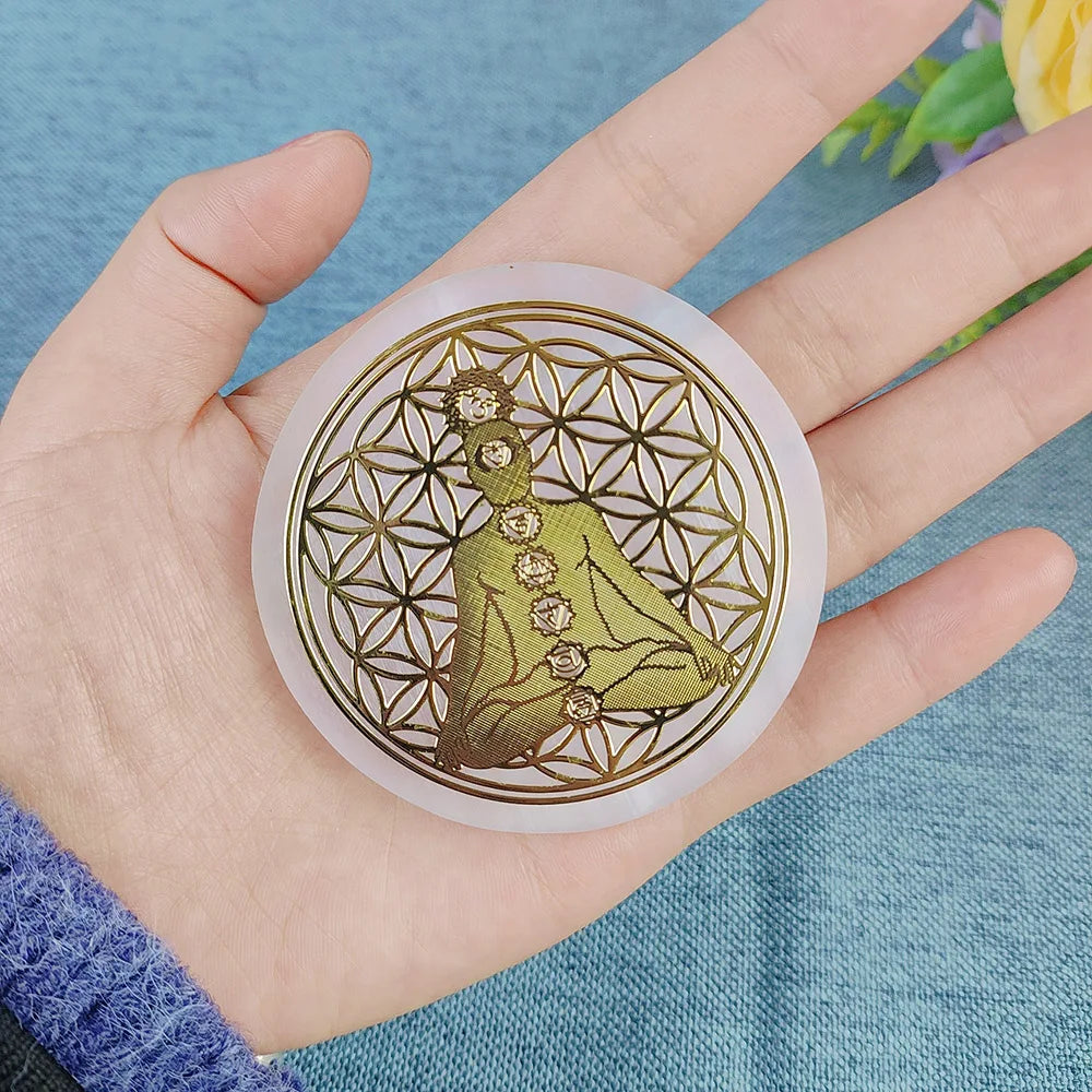 Decorative coaster with a floral design held in a hand against a blue fabric background