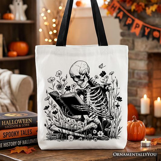 Tote bag with a skeleton reading a book design in a Halloween-themed setting.
