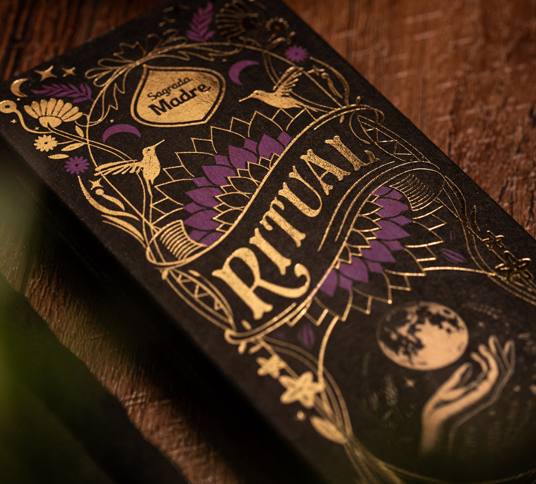 Decorative packaging with intricate gold and purple designs on a brown background