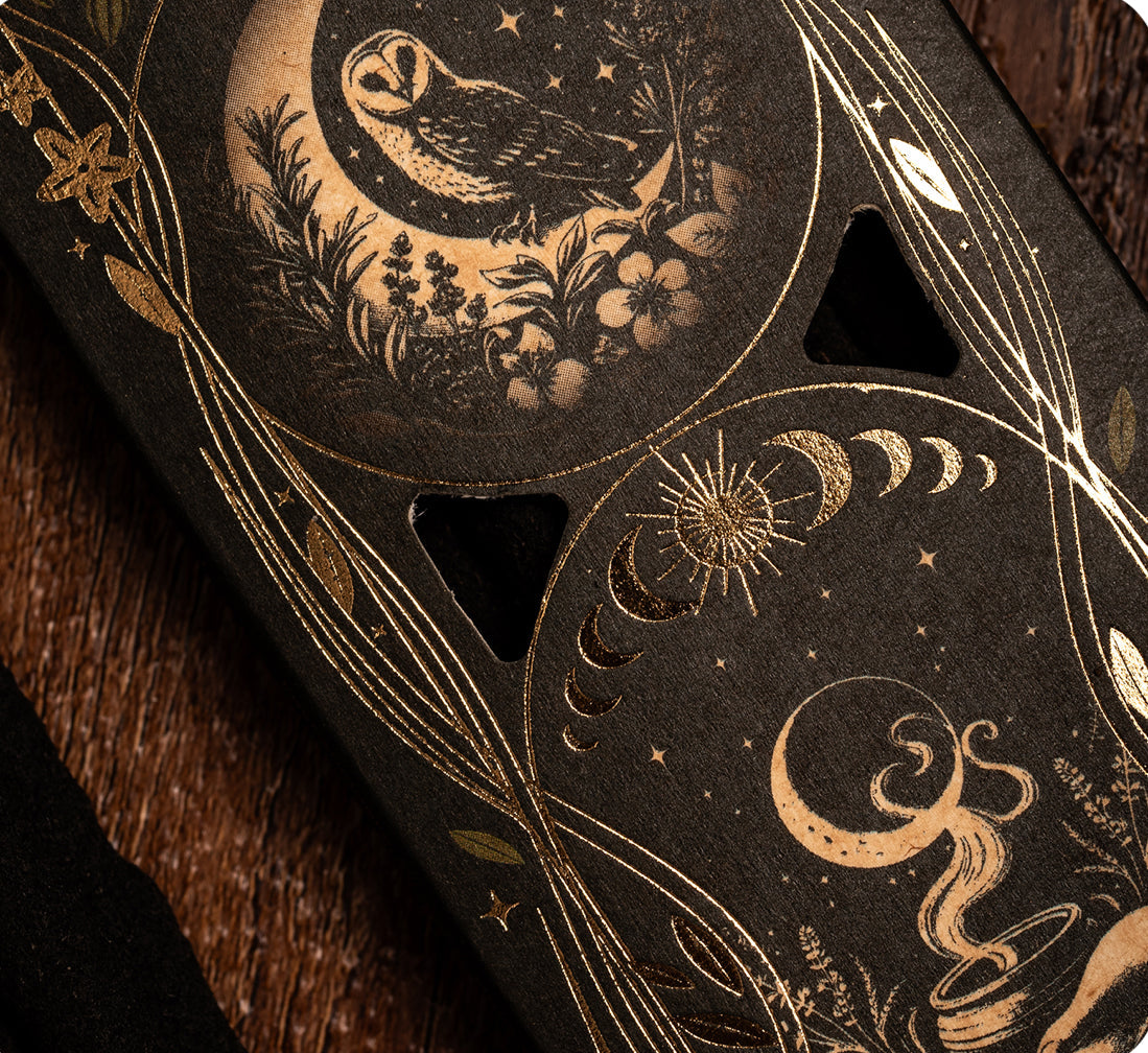 Decorative phone case with celestial design featuring an owl and moon phases on a dark background.
