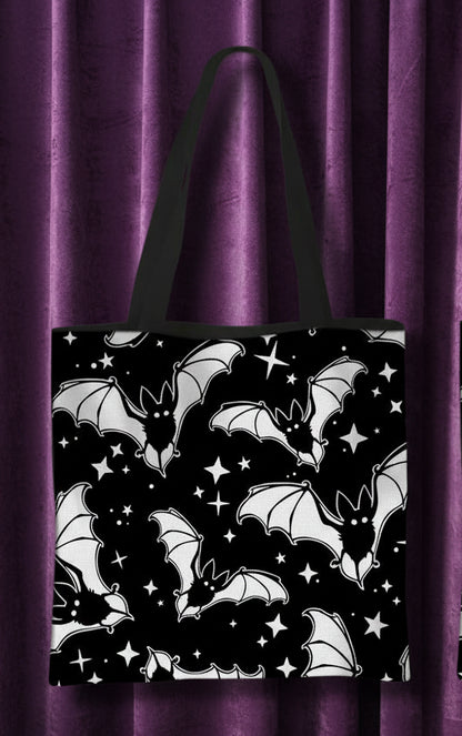 Front and back views of a black tote bag with a white bat and star pattern, shown on a plain white background with red text labels 'front' and 'back'.