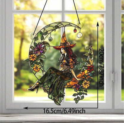 Decorative window hanging with a witch design, made with acrylic, not glass, on a window background.