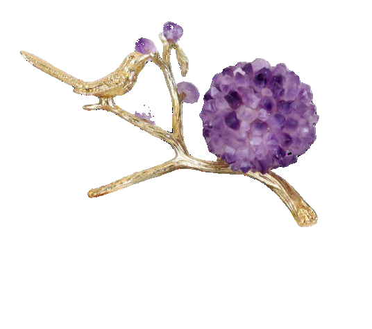 Decorative piece with gold bird and purple amethysts on books