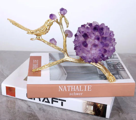Decorative piece with gold bird and purple amethysts on books