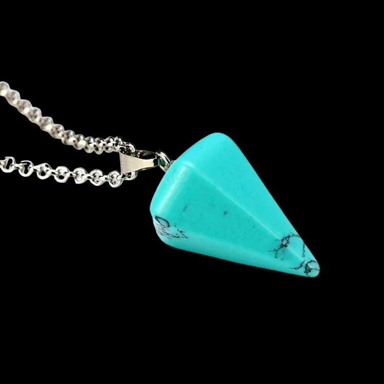 Turquoise triangular pendant on a silver chain against a white background