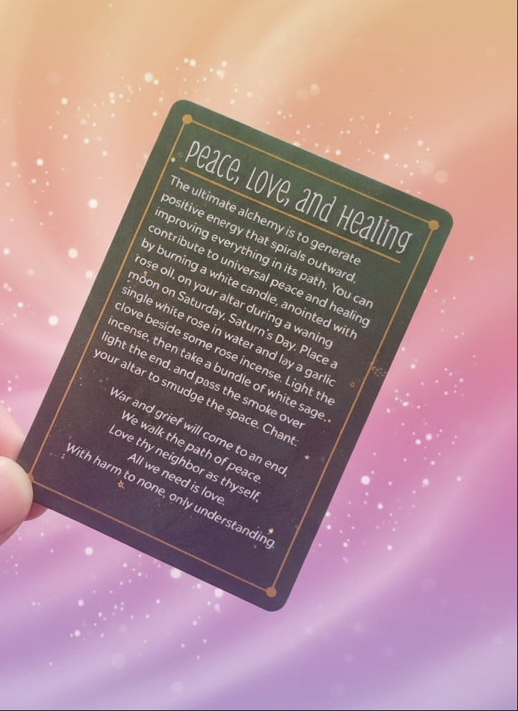 Green card with text on peace, love, and healing rituals held by a hand.