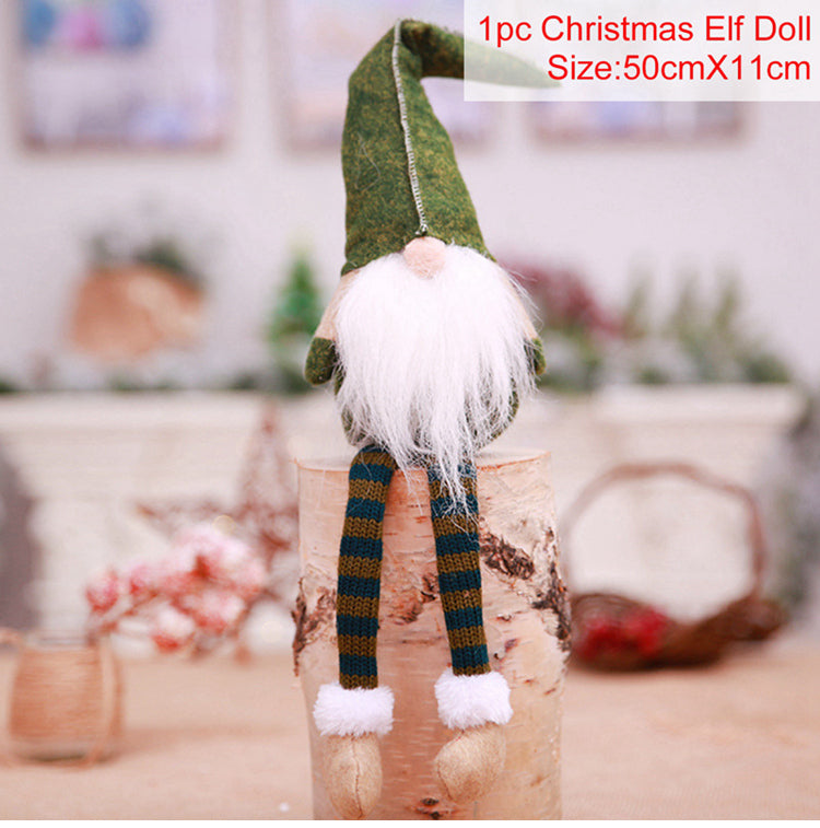 Christmas elf doll with green hat and striped pants on a wooden block with a blurred background