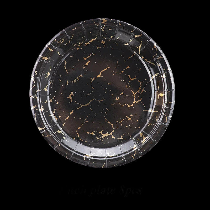 Black marble-patterned paper plate with gold accents on a white background