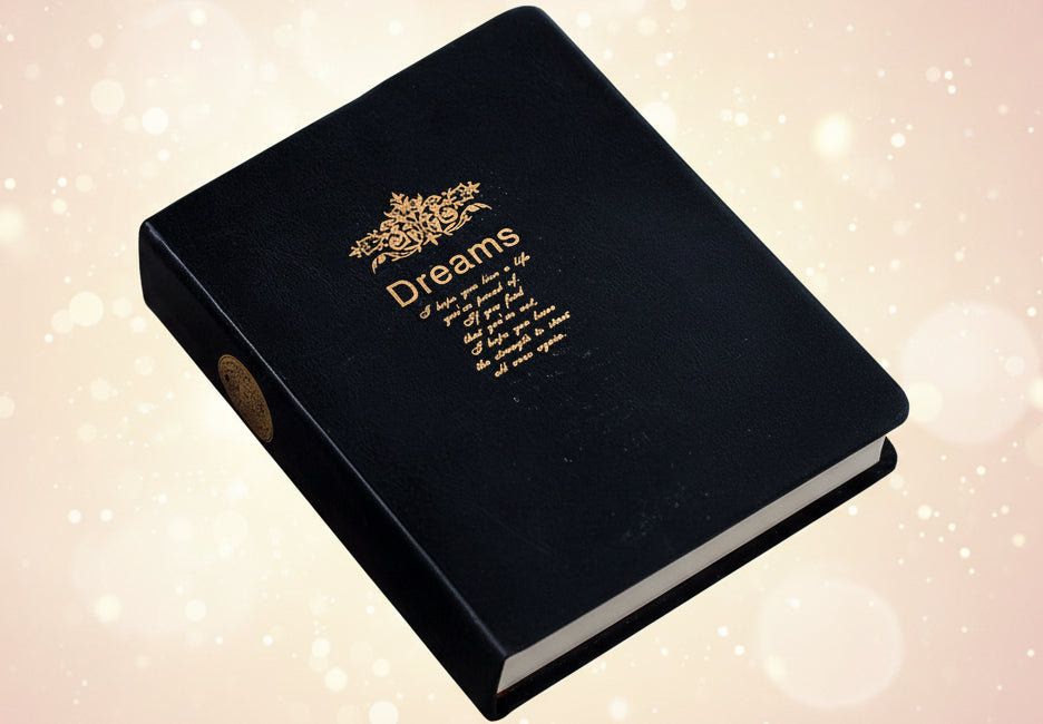 Black box with gold text and design on a wooden surface