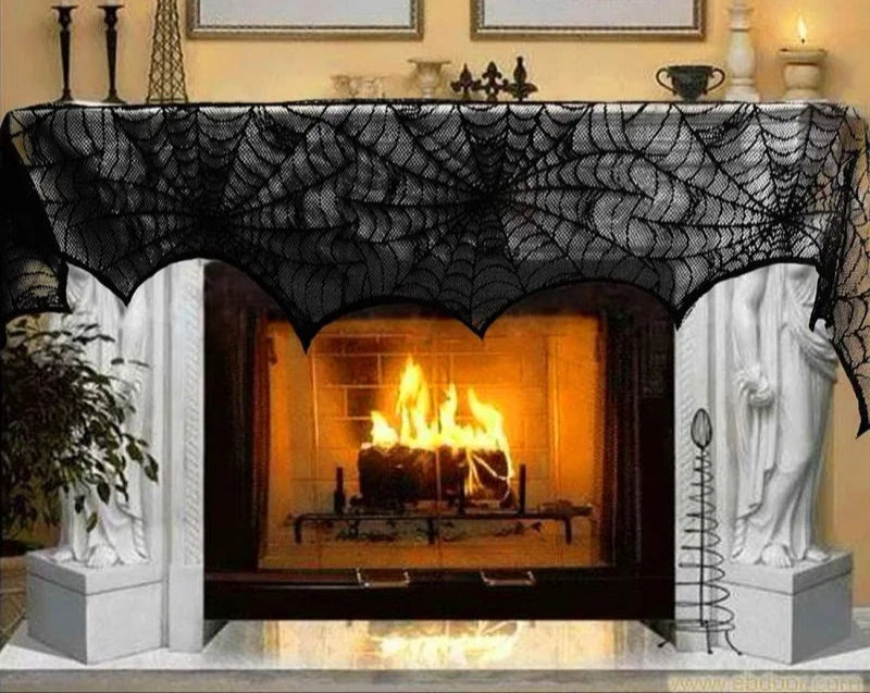 Halloween-themed fireplace with black spiderweb decor over a lit fireplace.
