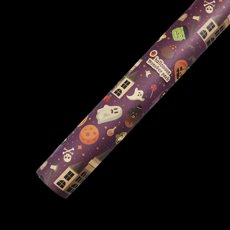 Roll of Halloween-themed paper with ghost, moon, and house designs on a purple background.