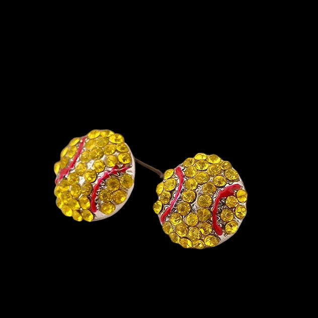 Yellow rhinestone earrings on a magazine