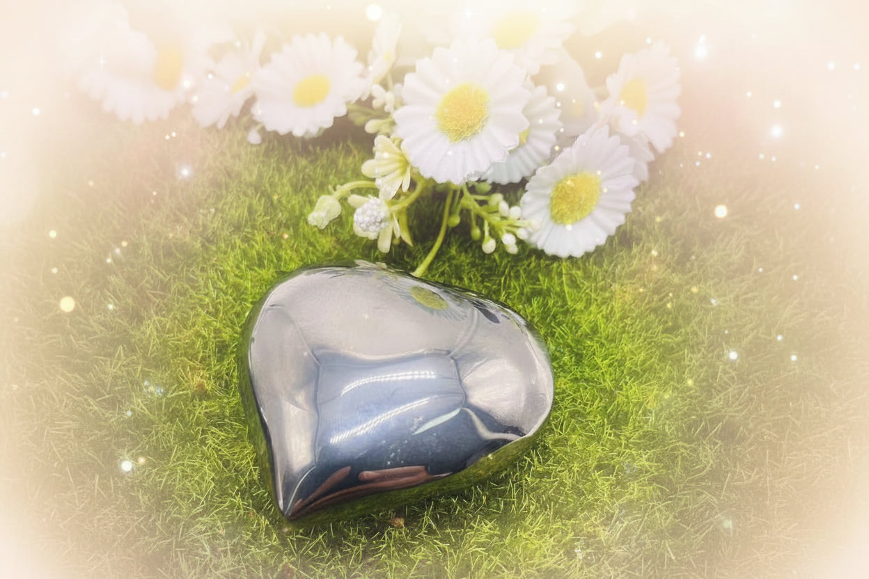 Polished stone on a green grass background with white flowers