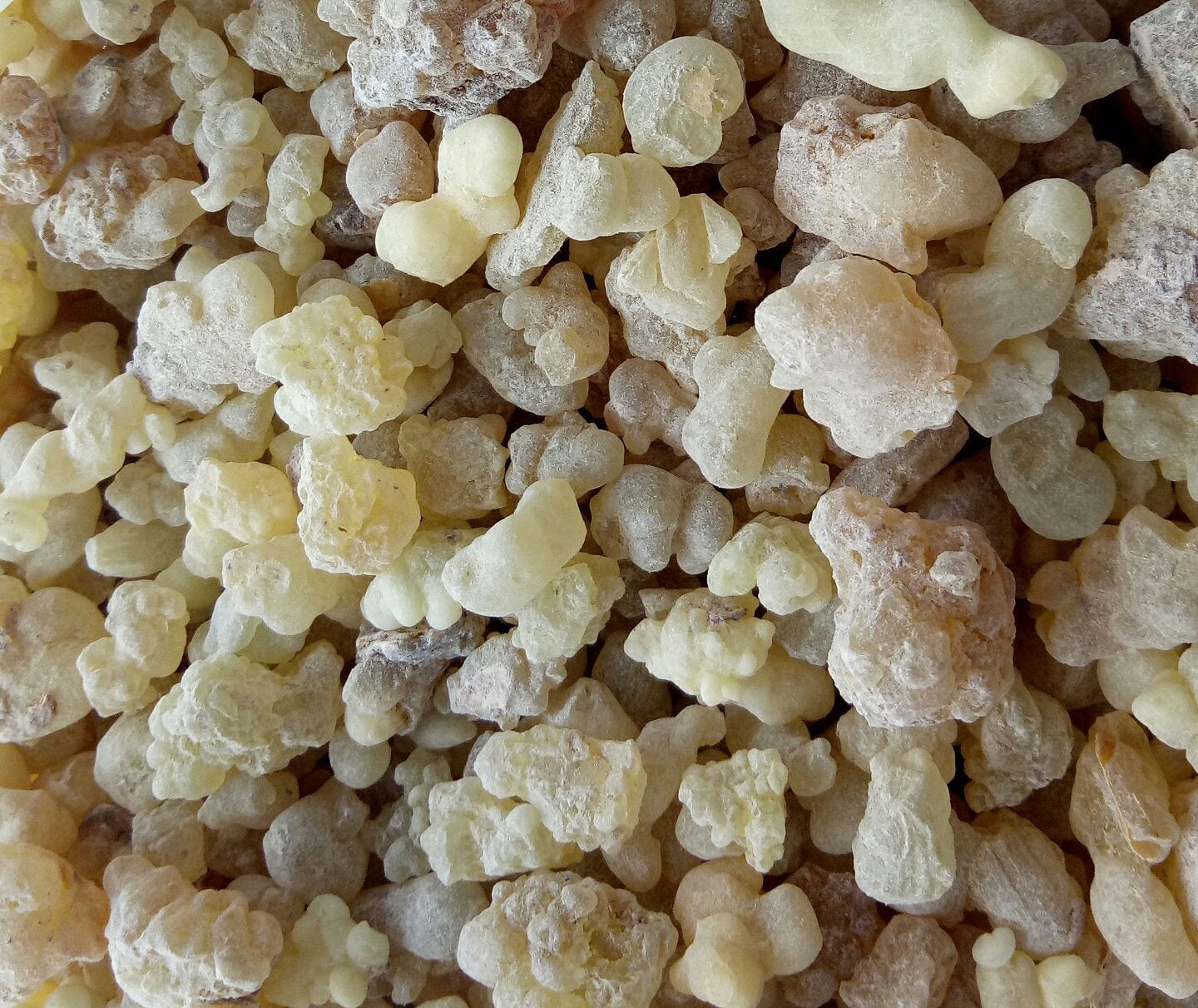 Close-up of a pile of resin-like material with various shapes and sizes.