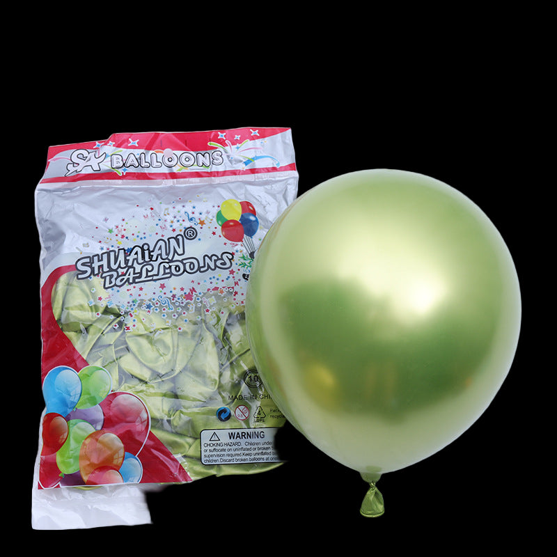Gold balloon next to its packaging on a white background