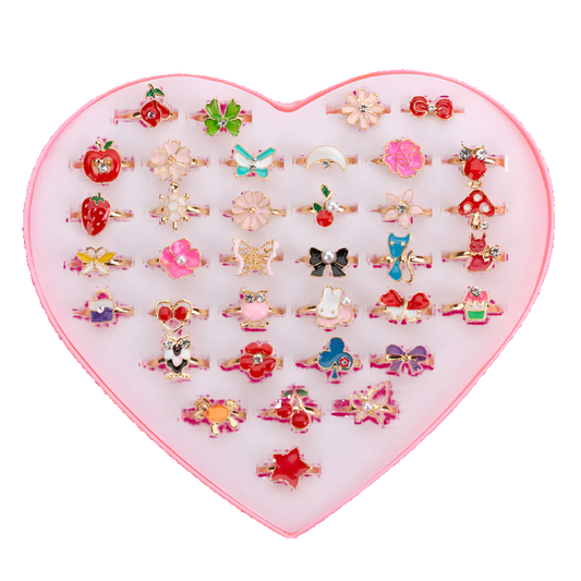 Set of small rings in a heart-shaped display box on a white background