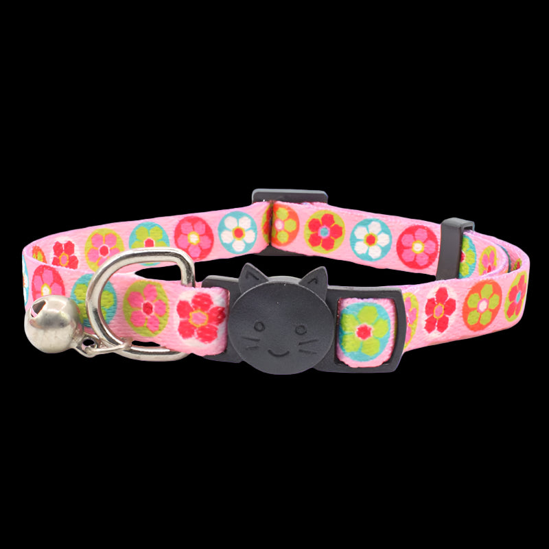 Pink floral cat collar with a bell on a white background