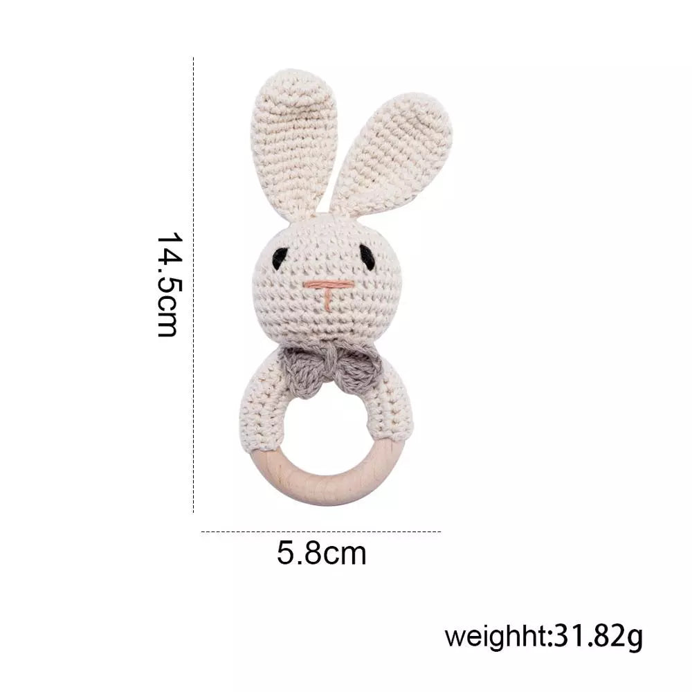Crocheted rabbit-shaped rattle with measurements and weight on a white background