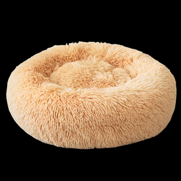 Fluffy peach-colored pet bed on a light gray background